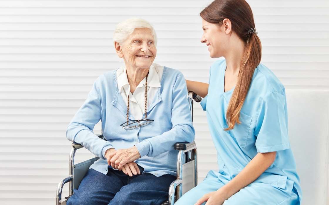 Angehörige sprechen mit Betreuungskraft über Regeln und Arbeitszeiten in der Betreuung zu Hause