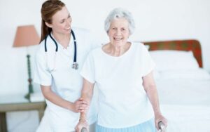 Seniorin wird bei einem Spaziergang von einer Betreuungsperson begleitet und bleibt dabei eigenständig